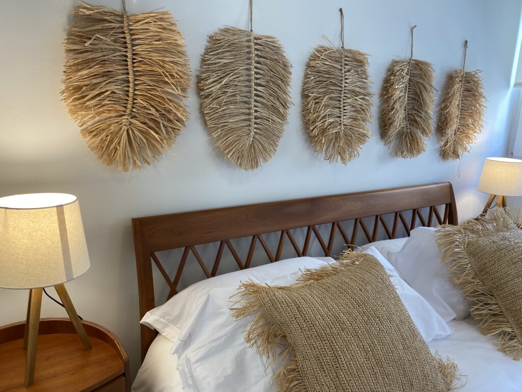 Dormitorio de estilo natural con decoraciones de paja en pared.